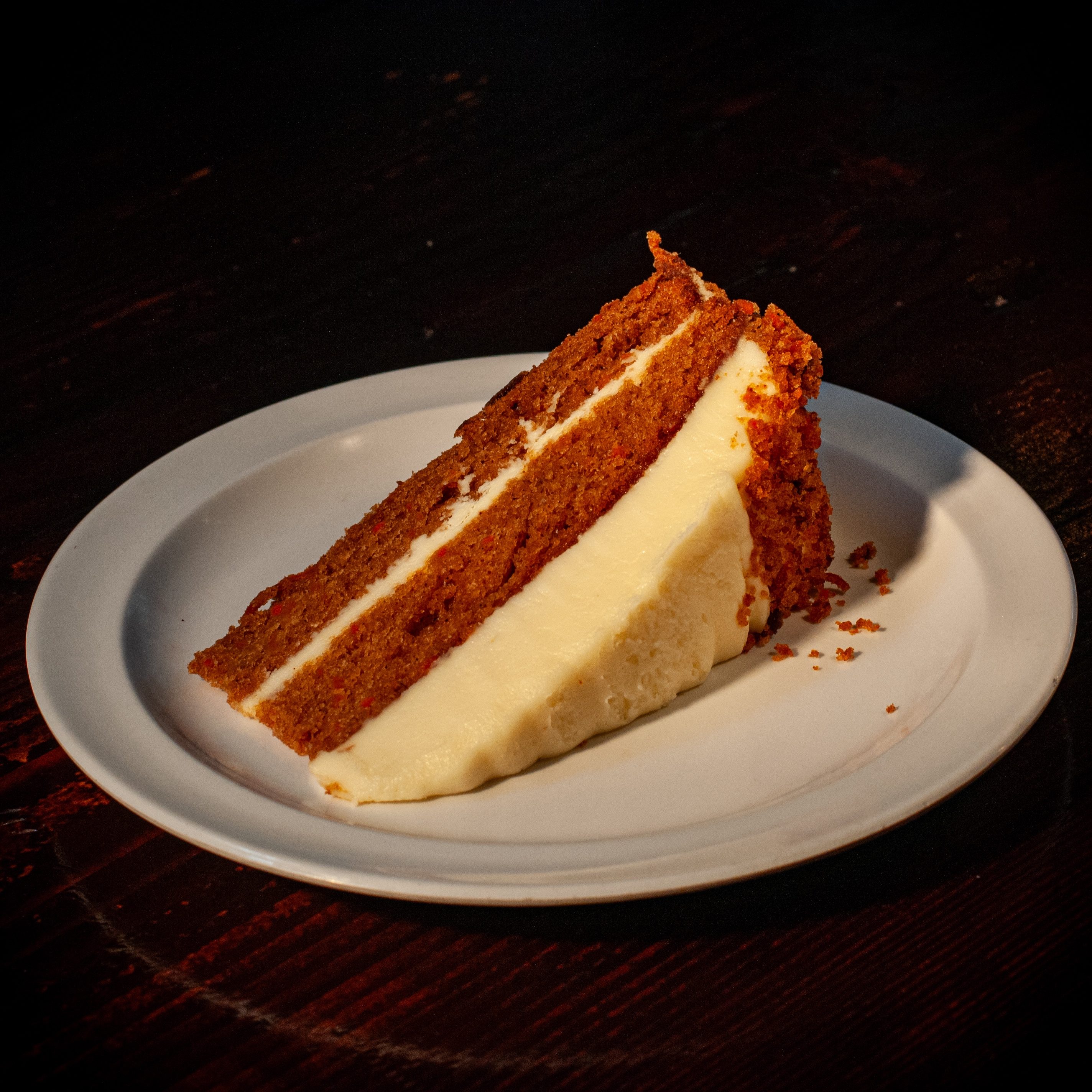 Four layer carrot cake slice.