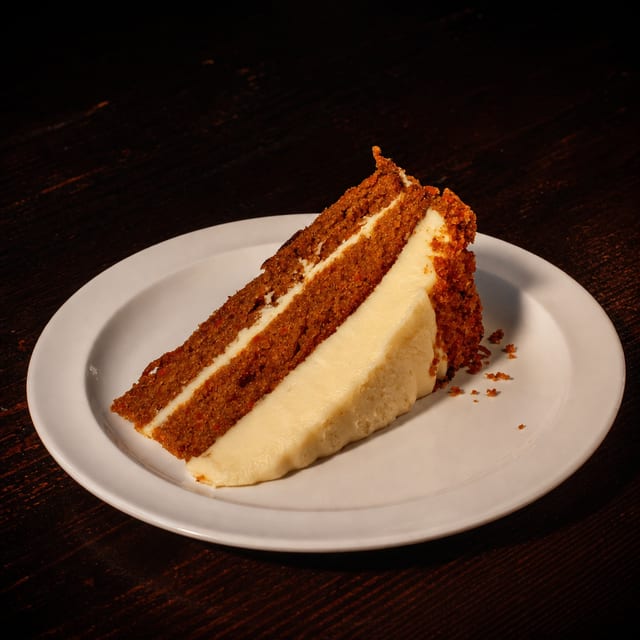 Four layer carrot cake slice.